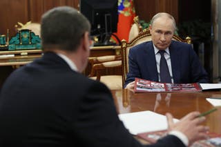 Russia's President Vladimir Putin (R) attends a meeting with Vladimir Region Governor Alexander Avdeyev (L) in Moscow